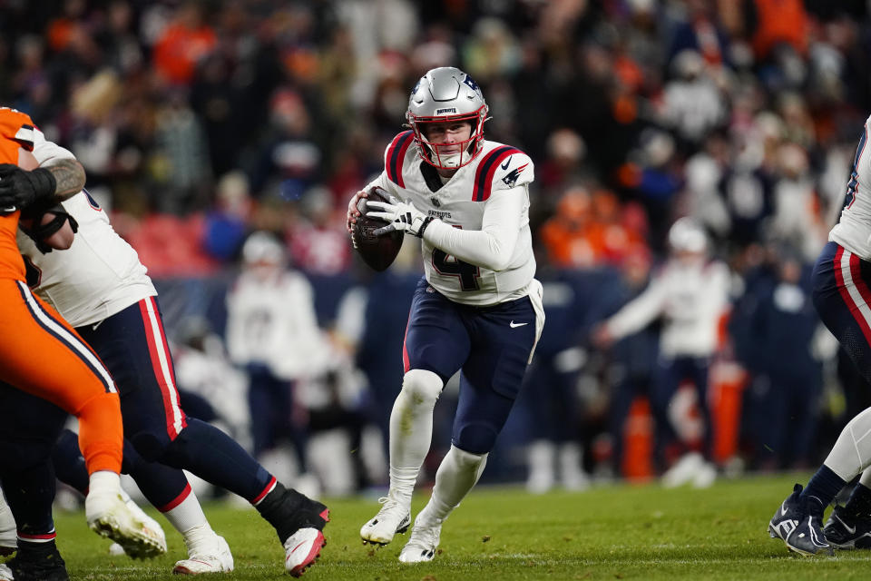 New England Patriots quarterback Bailey Zappe scrambles during the first half of an NFL football game against the Denver Broncos, Sunday, Dec. 24, 2023, in Denver. (AP Photo/Geneva Heffernan)