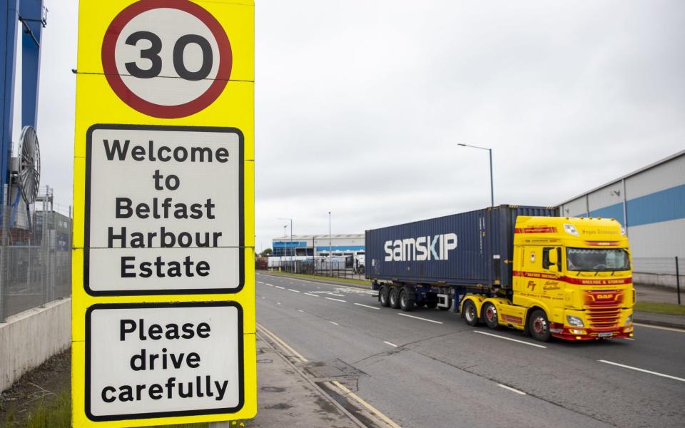 A haulage lorry driving past a sign at Belfast Port - Liam McBurney/PA Wire