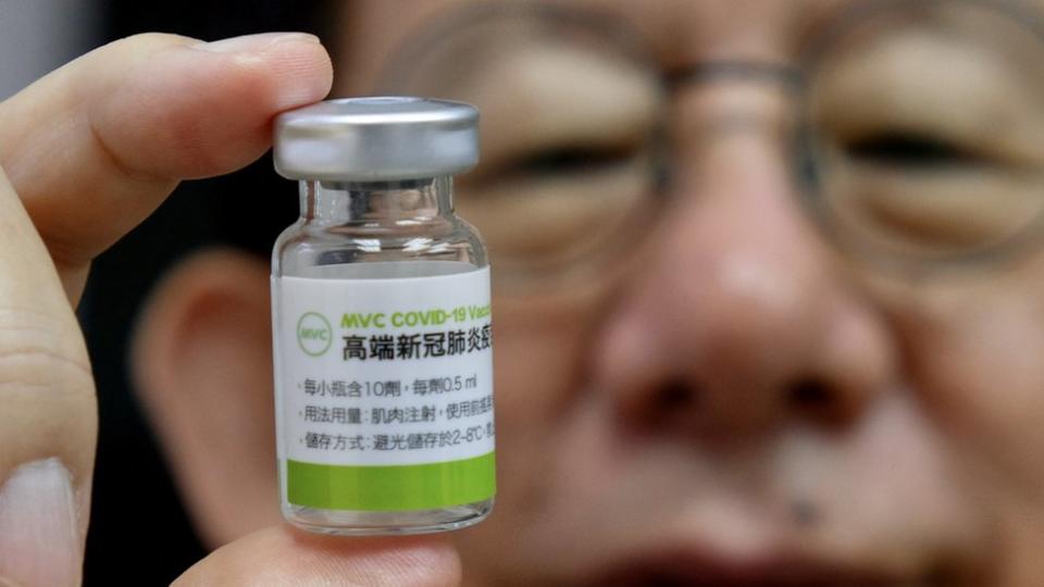 Charles Chen, Chief Executive Officer of Taiwans vaccine maker Medigen Vaccine Biologics Corp (MVC), poses for photographs with a vaccine sample at its headquarters in Taipei on June 16, 2021.