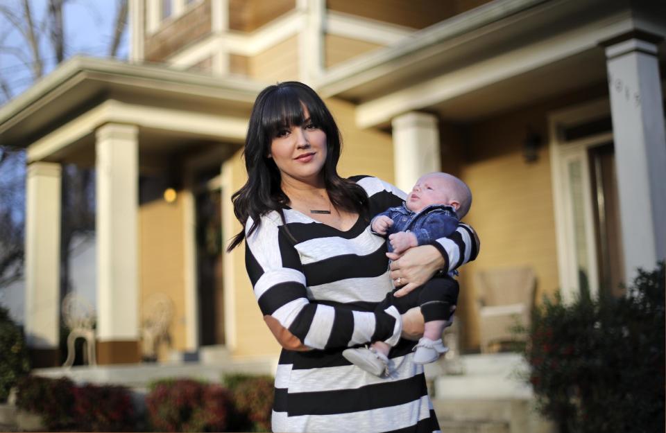 In this Jan. 31, 2017, photo, Rachel Potter holds her son, Jude, at their home in Nashville, Tenn. Potter, a Nashville-based singer who has toured the country as part of the cast of the hit musical "Wicked" as well as performing gigs with her country music band Steel Union, said she couldn't afford insurance before the Affordable Care Act. From a return to higher premiums based on female gender, to gaps in coverage for breast pumps used by nursing mothers, President Donald Trump's vow to repeal his predecessor's health care law is raising concerns about the impact on women's health. (AP Photo/Mark Humphrey)