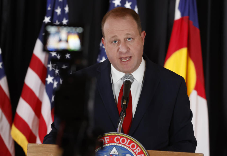 Colorado Gov. Jared Polis makes a point during a news conference to update the state's efforts to check the spread of the new coronavirus Monday, May 11, 2020, in Denver. Polis announced that a restaurant in Castle Rock, Colo., that opened Sunday in defiance of state rules barring in-person dining will have its business license suspended temporarily for the action. (AP Photo/David Zalubowski)