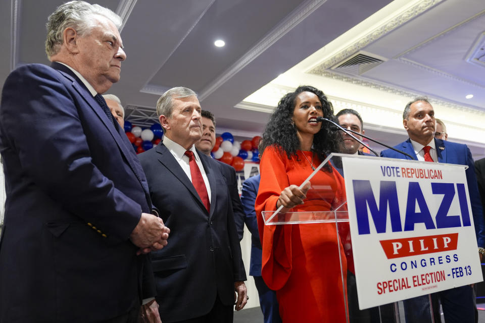 Republican candidate for New York's 3rd congressional district Mazi Pilip, center, is joined Nassau GOP Chairman Joe Cairo, second from left, and former congressman Peter King as she seeks to supporters during an election night party Tuesday, Feb. 13, 2024, in East Meadow, N.Y. (AP Photo/Mary Altaffer)