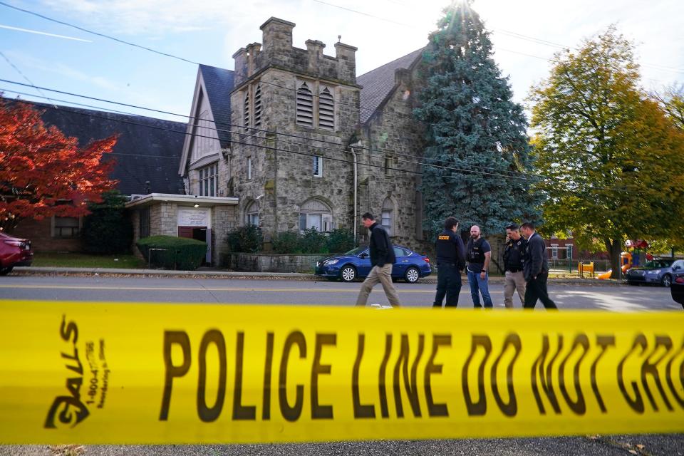 Police investigate the scene outside the Destiny of Faith Church in Pittsburgh, Friday Oct. 28, 2022, where a shooting while a funeral was being held, left six people wounded, including one person who was hospitalized in critical condition.