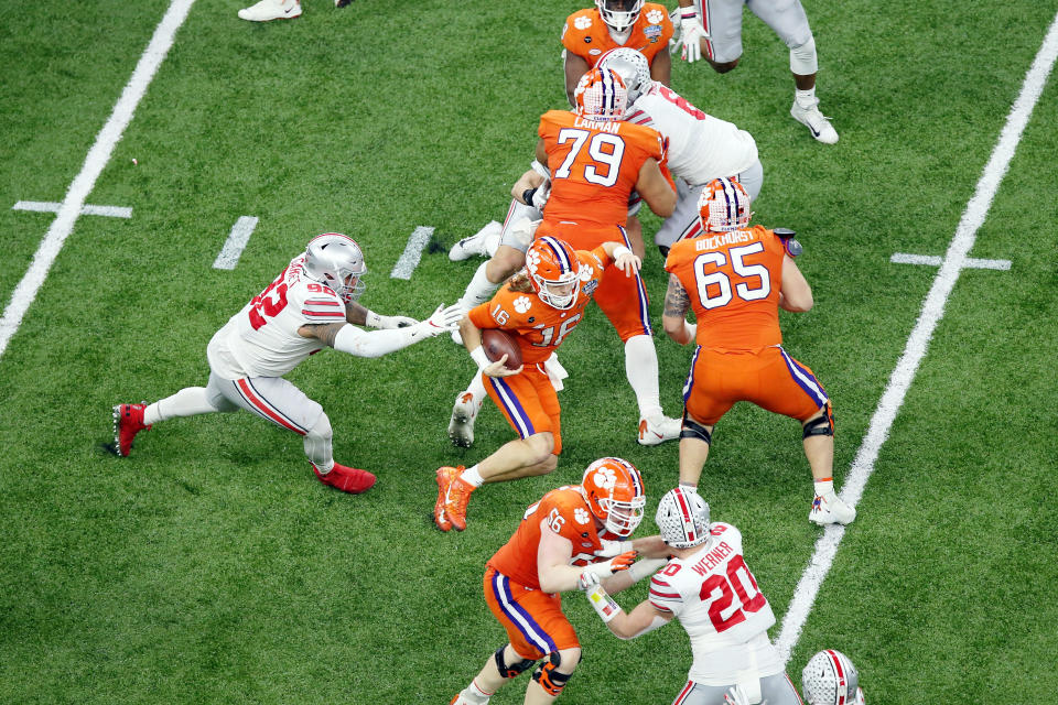 iJan 1, 2021; New Orleans, LA, USA; Clemson Tigers quarterback Trevor Lawrence (16) evades Ohio State Buckeyes defensive tackle Haskell Garrett (92) during the second quarter at Mercedes-Benz Superdome. Mandatory Credit: Russell Costanza-USA TODAY Sports