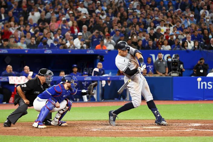 Aaron Judge #99 of the New York Yankees hits his 61st home run of the season in the seventh inning against the Toronto Blue Jays at Rogers Centre on September 28, 2022 in Toronto, Ontario, Canada. Judge has now tied Roger Maris for the American League record.