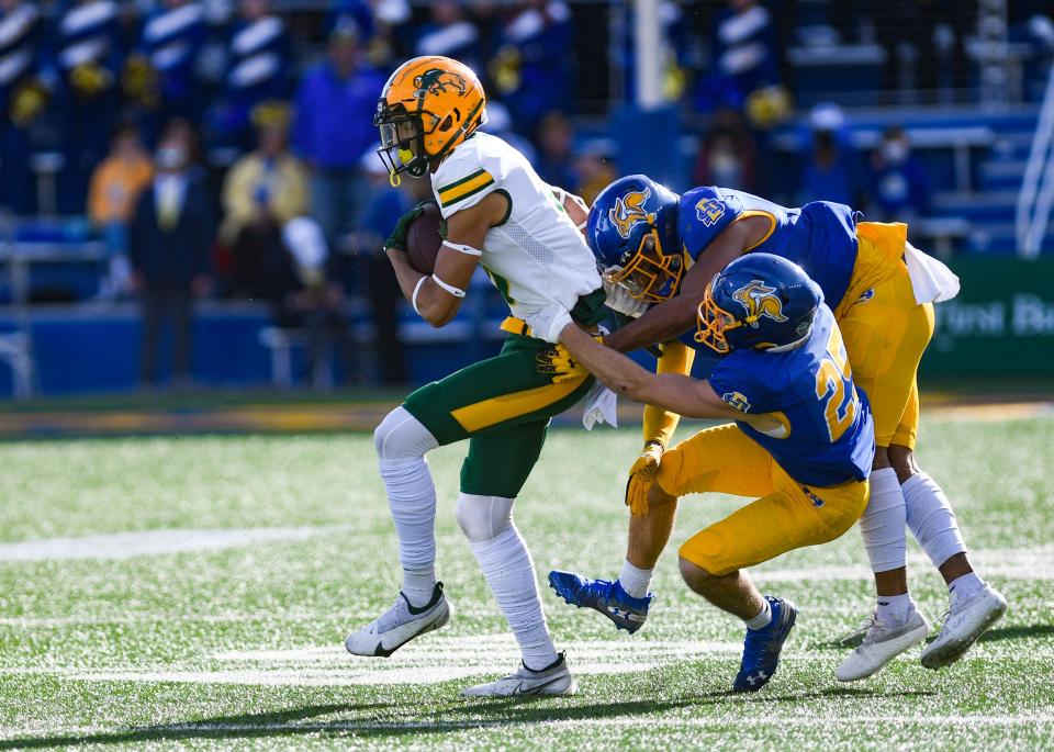 North Dakota State's Zach Mathis is tackled by multiple South Dakota State players in the annual Dakota Marker game on Saturday, November 6, 2021 at Dana J. Dykhouse Stadium in Brookings.