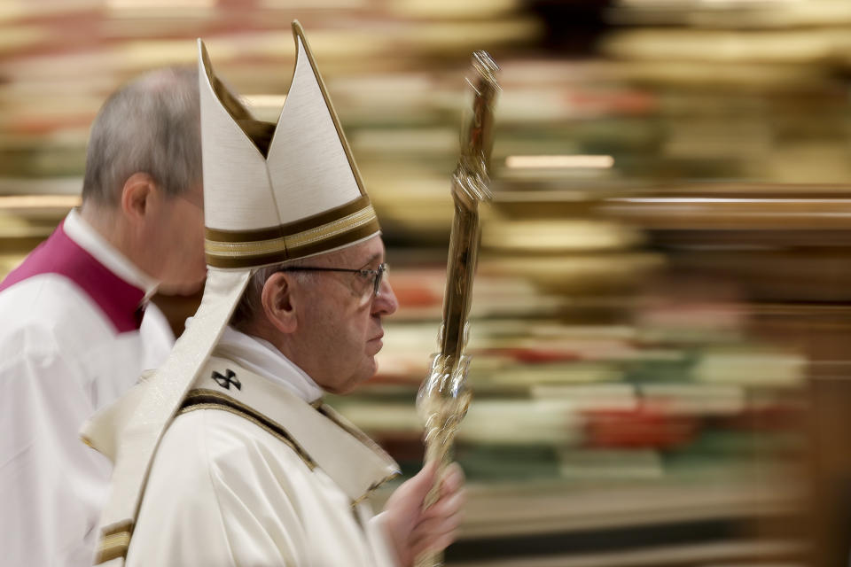 In this photo taken with slow shutter speed Pope Francis leaves after celebrating an Epiphany Mass in St. Peter's Basilica at the Vatican, Sunday, Jan. 6, 2019. Pope Francis has appealed to European leaders to show “concrete solidarity” to 49 migrants stranded aboard a pair of rescue vessels. Francis, addressing faithful in St. Peter’s Square Sunday, noted that the migrants, rescued in the Mediterranean. (AP Photo/Andrew Medichini)