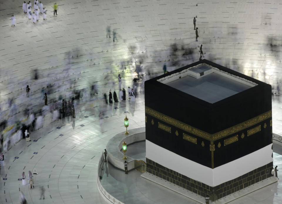 In this photo taken with low shutter speed, Muslim pilgrims circumambulate the Kaaba, the cubic building at the Grand Mosque, at the start the annual hajj pilgrimage, Sunday, July 18, 2021. The pilgrimage to Mecca required once in a lifetime of every Muslim who can afford it and is physically able to make it, used to draw more than 2 million people. But for a second straight year it has been curtailed due to the coronavirus with only vaccinated people in Saudi Arabia able to participate. (AP Photo/Amr Nabil)