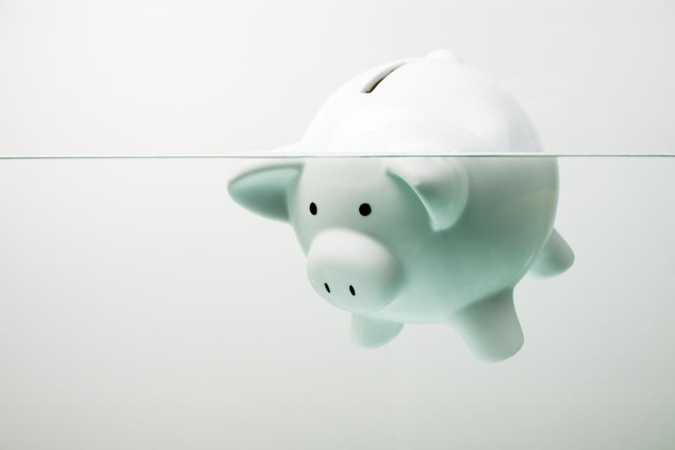 Classic white piggy bank floating in water