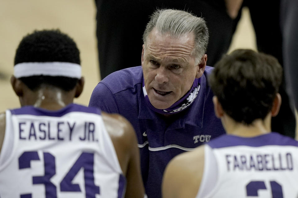 TCU head coach Jamie Dixon talks to his players during the first half of an NCAA college basketball game against Liberty Sunday, Nov. 29, 2020, at the T-Mobile Center in Kansas City, Mo. (AP Photo/Charlie Riedel)