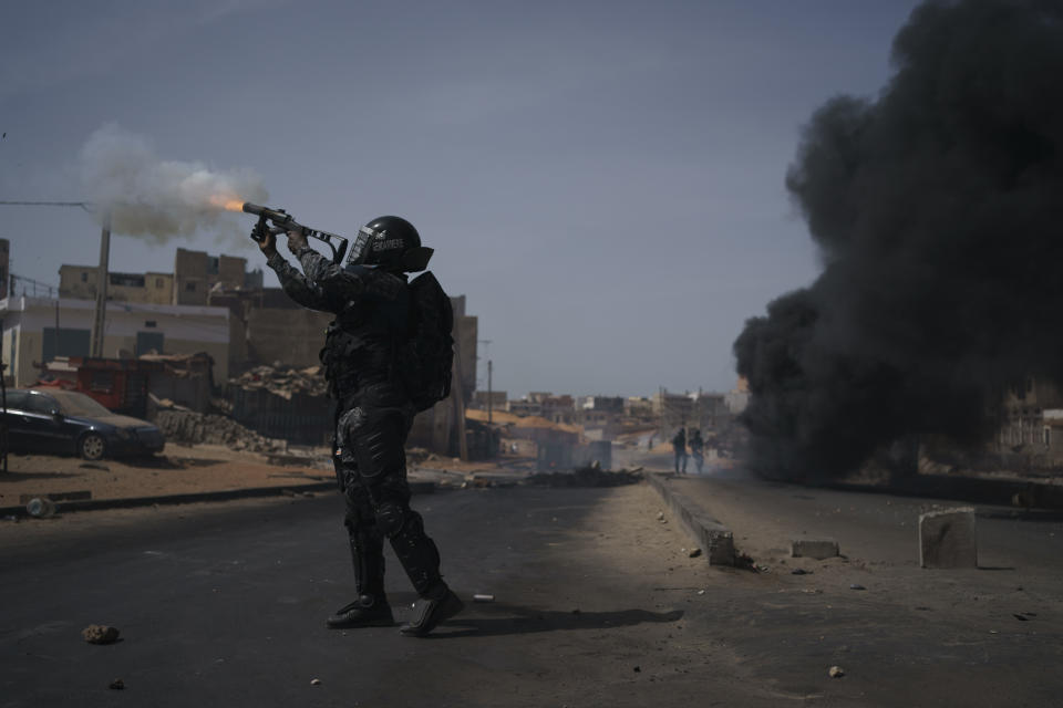 A riot police fires tear gas at demonstrators during a protest at a neighborhood in Dakar, Senegal, Friday, June 2, 2023. Clashes between police and supporters of Senegalese opposition leader Ousmane Sonko left nine people dead, the government said Friday, with authorities issuing a blanket ban on the use of several social media platforms in the aftermath of the violence (AP Photo/Leo Correa)