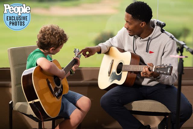 <p>J. Anthony Martinez Photography</p> Ron Artis II with a young recipient of a guitar