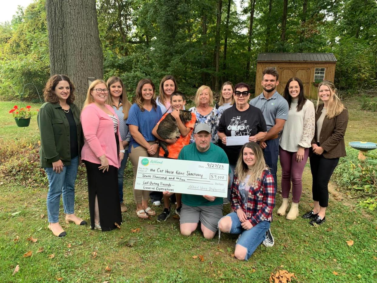 Representatives of Ashland Young Professionals present proceeds from their recent “Putts for Pets” golf outing to The Cat House Feline Sanctuary.