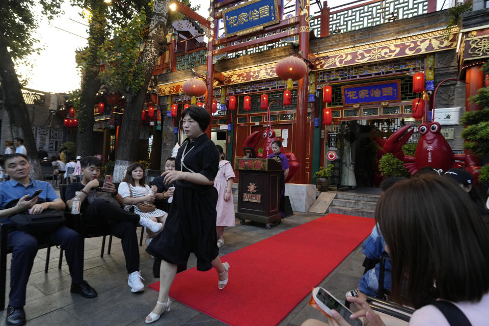 Customers queue up at a popular crayfish restaurant in Beijing, Tuesday, Aug. 15, 2023. Chinese leader Xi Jinping has called for patience in a speech released as the ruling Communist Party tries to reverse a deepening economic slump and said Western countries are "increasingly in trouble" because of their materialism and "spiritual poverty." (AP Photo/Ng Han Guan)