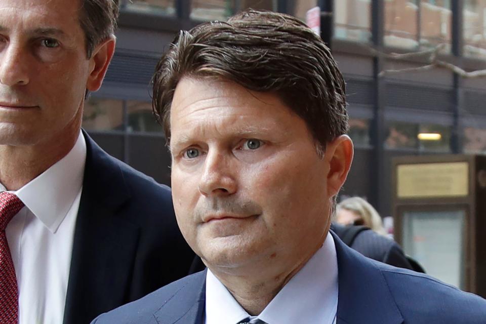 Devin Sloane, right, arrives at federal court for sentencing in a nationwide college admissions bribery scandal, Tuesday, Sept. 24, 2019, in Boston. Sloane admitted to paying $250,000 to get his son into the University of Southern California as a fake athlete.