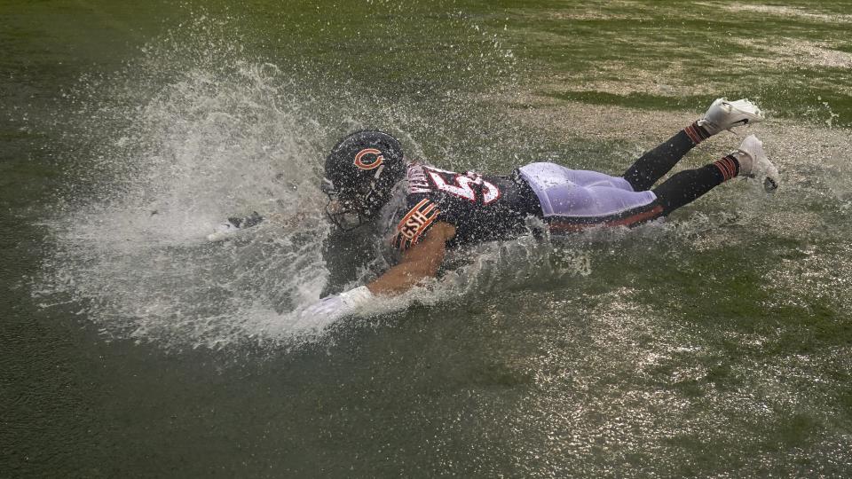 Chicago Bears' Sterling Weatherford celebrates by sliding in a puddle after an NFL football game against the San Francisco 49ers Sunday, Sept. 11, 2022, in Chicago. The Bears won 19-10. (AP Photo/Nam Y. Huh)