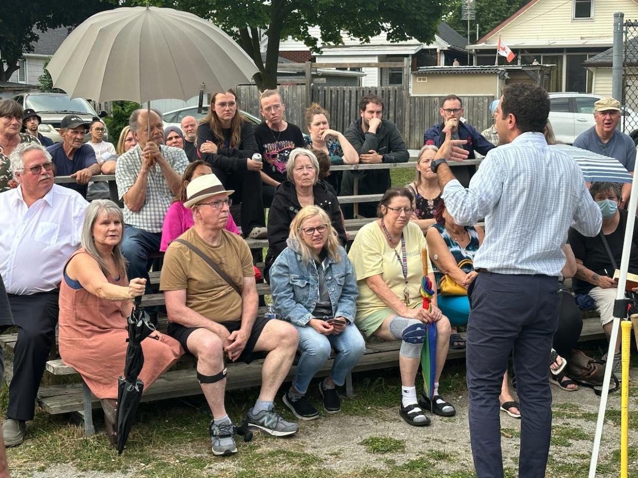 Ward 2 Coun. Fabio Costante addresses the crowd at a public meeting over the proposed Homelessness, Housing Hep Hub. (Dale Molnar/CBC - image credit)