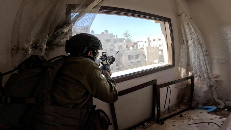 PHOTO: An Israeli soldier fires a weapon from a window during operations in the Gaza Strip amid the ongoing conflict between Israel and the Palestinian Islamist group Hamas, Dec. 4, 2023.  (Israel Defense Forces via Reuters)