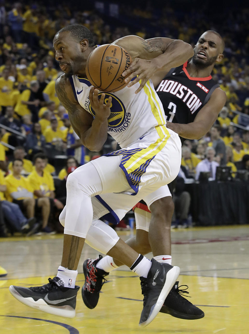 Golden State Warriors guard Andre Iguodala, left, drives to the basket against Houston Rockets guard Chris Paul (3) during the second half of Game 1 of a second-round NBA basketball playoff series in Oakland, Calif., Sunday, April 28, 2019. (AP Photo/Jeff Chiu)