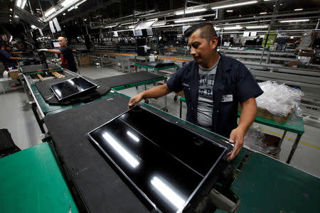 FILE PHOTO: An employee works at an LED TV assembly line at a factory that exports to the U.S. in Ciudad Juarez, Mexico, September 21, 2016. Picture taken September 21, 2016. REUTERS/Jose Luis Gonzalez/File Photo