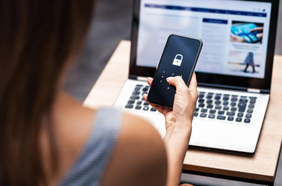 A woman putting a password in her phone