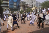 Two factions of protestors clash after Friday prayers at Baitul Mokarram mosque in Dhaka, Bangladesh, Friday, March 26, 2021. Witnesses said violent clashes broke out after one faction of protesters began waving their shoes as a sign of disrespect to Indian Prime Minister Narendra Modi, and another group tried to stop them. Local media said the protesters who tried to stop the shoe-waving are aligned with the ruling Awami League party. The party criticized the other protest faction for attempting to create chaos in the country during Modi’s visit. (AP Photo/Mahmud Hossain Opu)