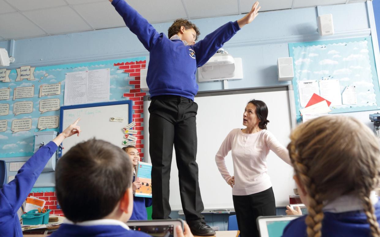 Stock image of boy misbehaving in class