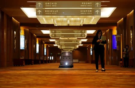 A robot cleans the hallway of the Marina Bay Sands convention centre in Singapore June 30, 2016. Picture taken June 30, 2016. REUTERS/Edgar Su