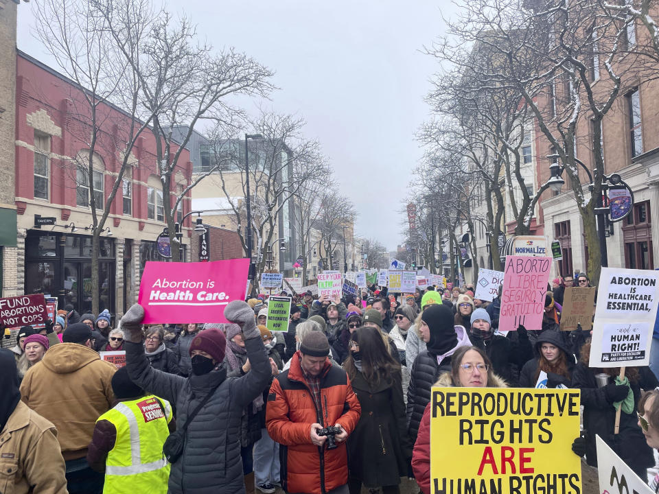 Abortion rights supporters marched down State Street in downtown Madison, Wis., on Sunday, Jan. 22, 2023. Thousands of protesters from Wisconsin and neighboring states descended on the state Capitol in Madison on Sunday to protest the state's restrictive abortion ban. (AP Photo/Harm Venhuizen)