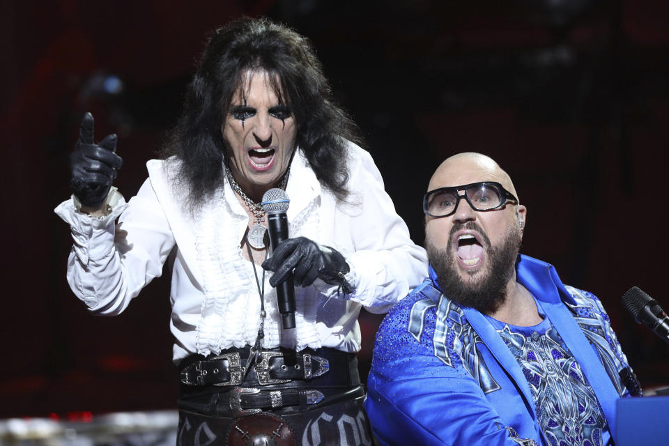 FILE - Veteran hard rock artist Alice Cooper, left, performs with the concert organized by U.S. songwriter and producer Desmond Child, right, at an ancient open air theater under the Acropolis in Athens on Monday, June 27, 2022. Cooper, an avid golfer, will be part of a monthly radio show with PGA Tour golfer Rocco Mediate. (AP Photo/Thomas Daskalakis)