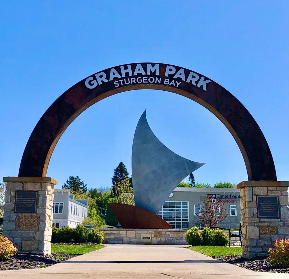 A new archway entrance to the remodeled Graham Park in Sturgeon Bay frames "Confluence," a water feature with a sculptural sail set in a fountain. A ribbon cutting will take place to officially reopen the park at 11 a.m. June 3.