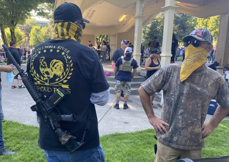 A Proud Boys member stands guard at a memorial gathering for Aaron "Jay" Danielson.