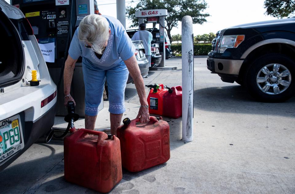 Alva resident Franceil Williams fills gas containers at BJÕs Wholesale Club in Fort Myers off of Six Mile Cypress neat Colonial Boulevard on Saturday Sept. 24, 2022. She was filling up for her generator in anticipation of Hurricane Ian.