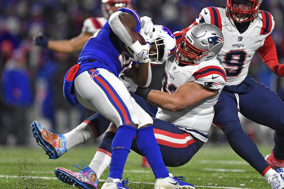 Buffalo Bills running back Devin Singletary, left, is tackled by New England Patriots defensive end Lawrence Guy. (AP Photo/Adrian Kraus)