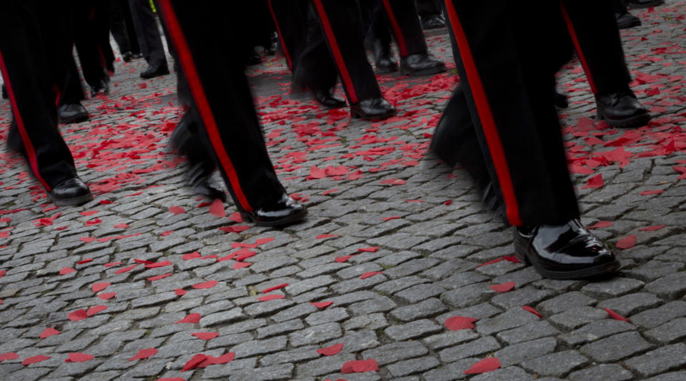 Soldiers march through paper poppies during an Armistice ceremony at the Menin Gate in Ypres, Belgium, Sunday, Nov. 11, 2018. Sunday marks exactly 100 years since the end of the First World War. (AP Photo/Virginia Mayo)