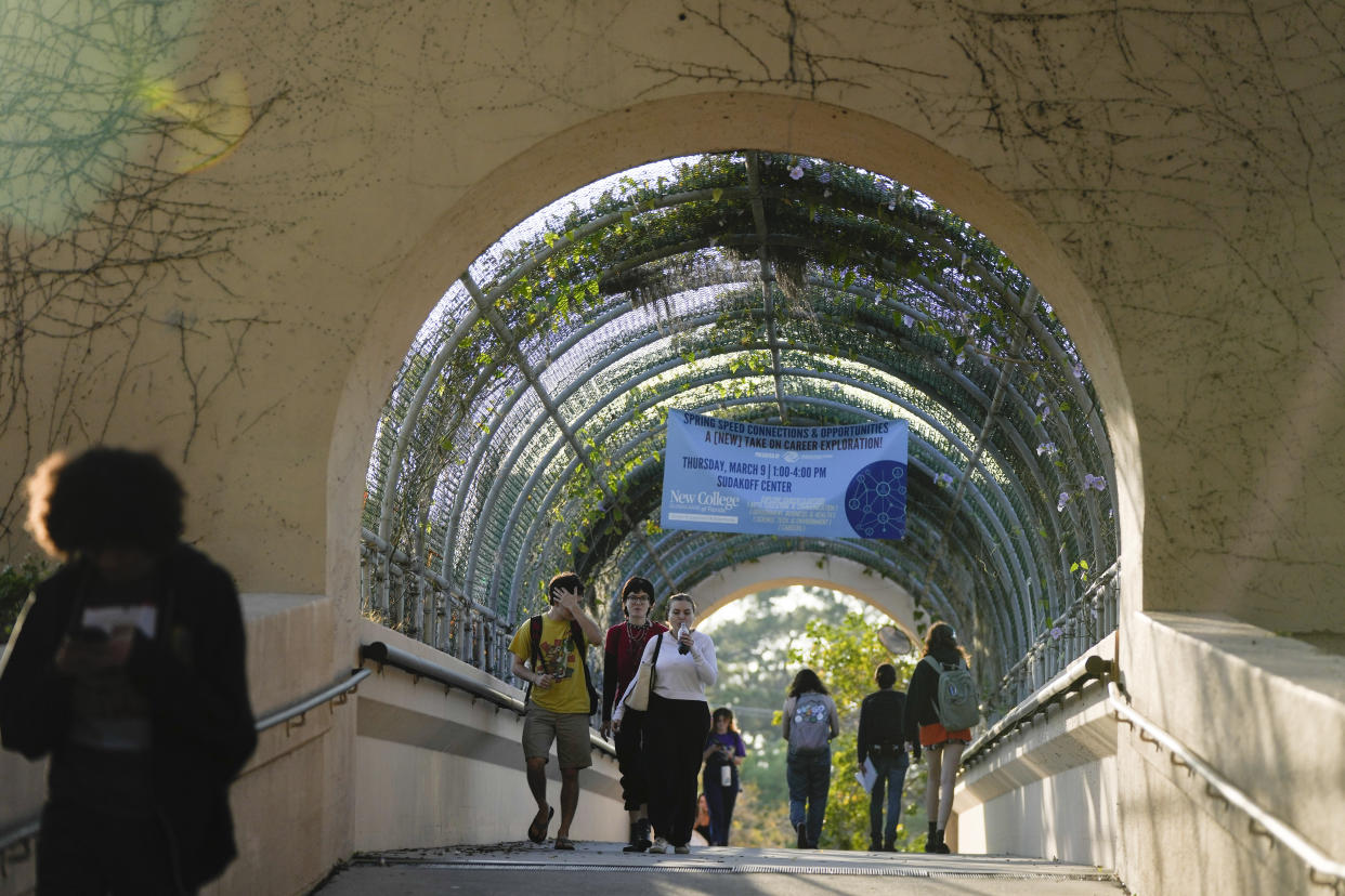 Students cross a bridge linking different sections of the campus, at New College of Florida, Tuesday, Feb. 28, 2023, in Sarasota, Fla. For years, students have come to this public liberal arts college on the western coast of Florida because they were self-described free thinkers. Now they find themselves caught in the crosshairs of America's culture war. (AP Photo/Rebecca Blackwell)