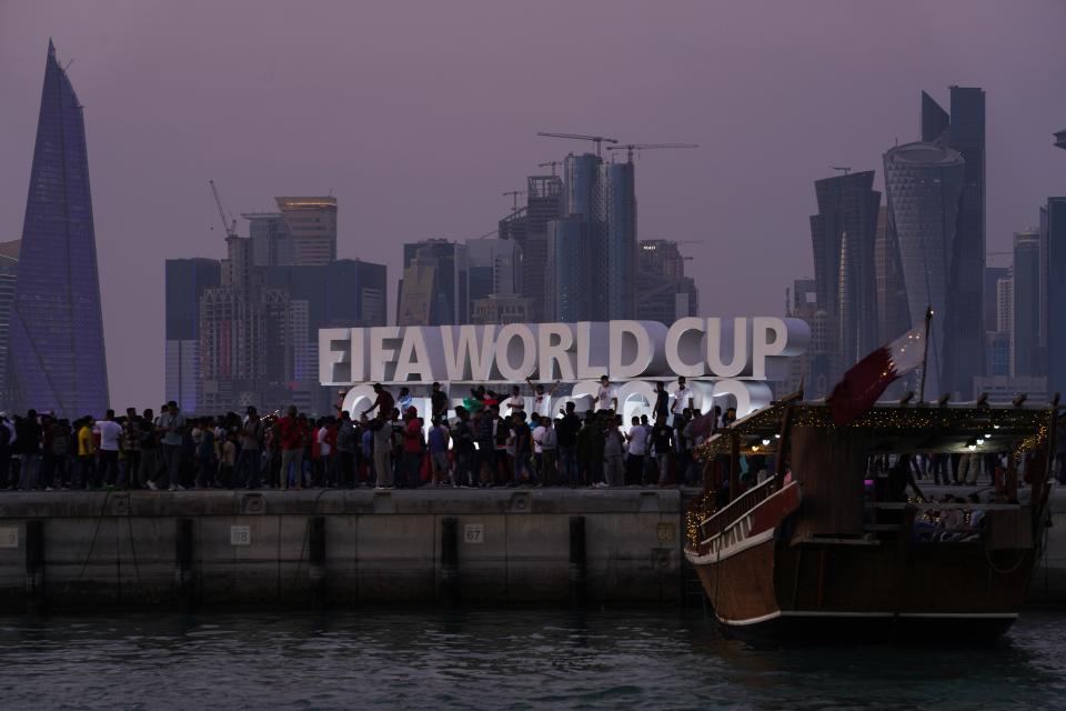 Fans celebrate in Doha, Qatar, Friday, Nov. 18, 2022. Fans poured into Qatar on Friday ahead of the Middle East's first World Cup as Doha ordered beers not to be poured out at stadiums during the tournament — a last-minute surprise largely welcomed by the country's conservative Muslims and shrugged off by giddy fans. (AP Photo/Jon Gambrell)