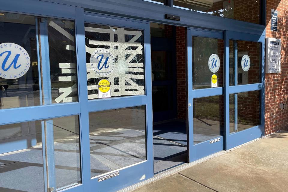 Tape covers a broken window on a door of the Student Union building, on the University of Connecticut campus, in Storrs, Conn., Tuesday, April 4, 2023.