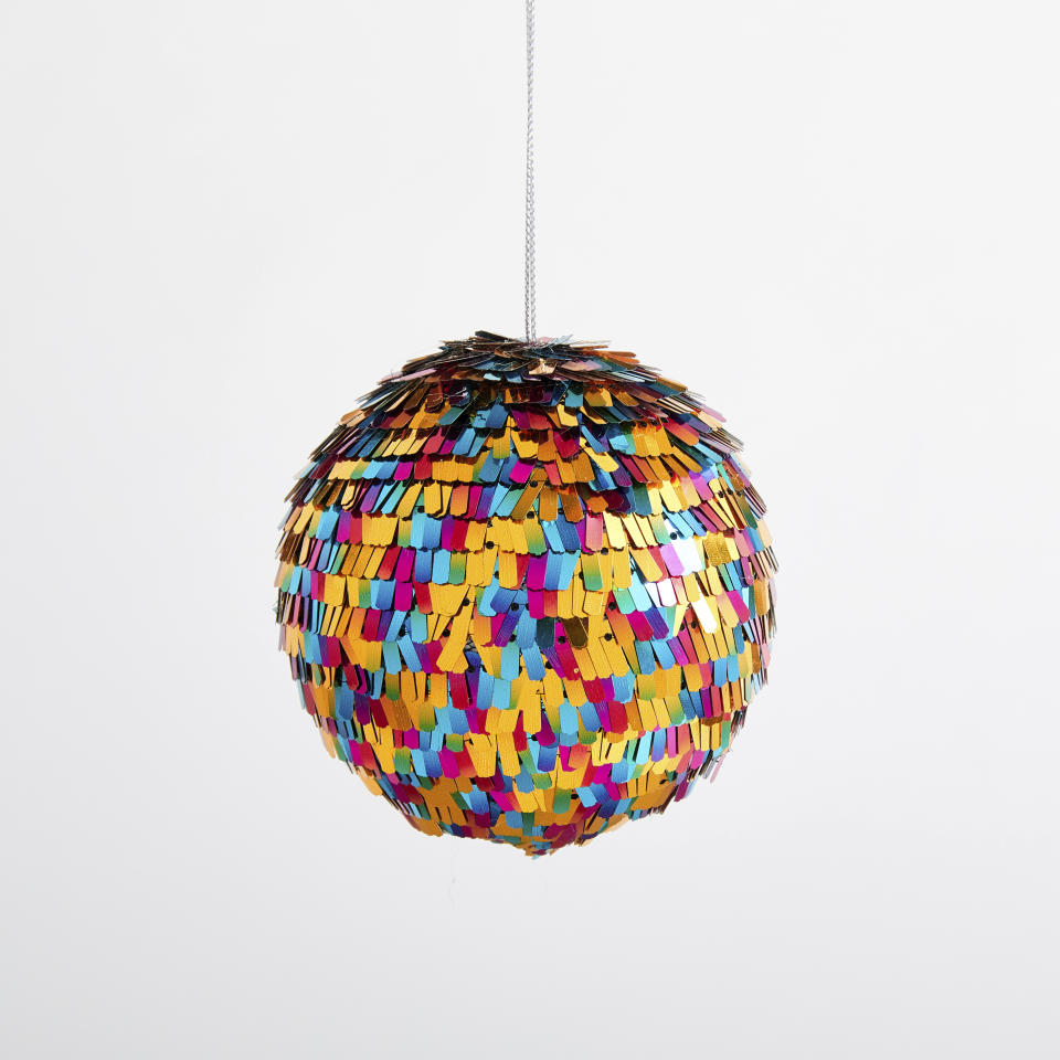 This undated photo shows West Elm's playful Fringe Disco Ball, which is covered in brightly-hued metallic confetti. (West Elm via AP)