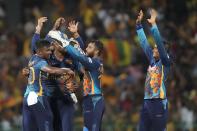 Sri Lanka's Pramod Madushan, left, celebrates after taking the wicket of Australia's Mitchell Marsh with teammates during the fifth one-day international cricket match between Australia and Sri Lanka in Colombo, Sri Lanka, Friday, June 24, 2022. (AP Photo/Eranga Jayawardena)