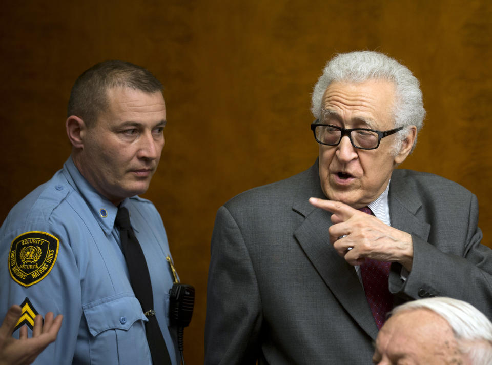 U.N. mediator for Syria Lakhdar Brahimi, right, gestures as he leaves a press briefing at the United Nations headquarters in Geneva, Switzerland, Monday, Jan. 27, 2014. Syrians on opposite sides of their country’s civil war tried again Monday to find common ground, with peace talks focusing on an aid convoy to a besieged city that once more came under mortar attack from the government. (AP Photo/Anja Niedringhaus)