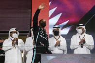 Mercedes driver Lewis Hamilton of Britain waves from the podium after winning the Qatar Formula One Grand Prix. In Lusail, Qatar, Sunday, Nov. 21, 2021. (Hamad I Mohammed, Pool via AP)