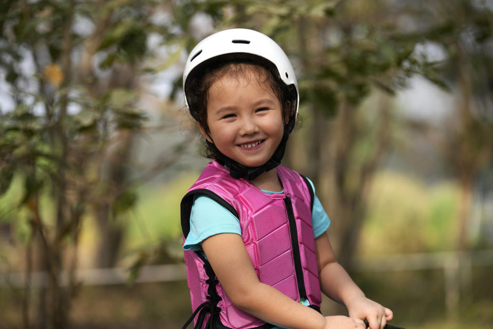 Rylae-Ann Poulin smiles as she learns to ride a horse in Bangkok, Thailand, Saturday, Jan. 14, 2023. Rylae-Ann was among the first to benefit from a new way of delivering gene therapy _ directly into the brain _ that experts believe holds great promise for treating a host of brain disorders. (AP Photo/Sakchai Lalit)