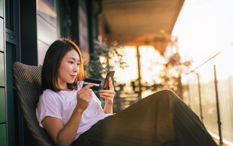 woman using smart phone and credit card to mange online banking