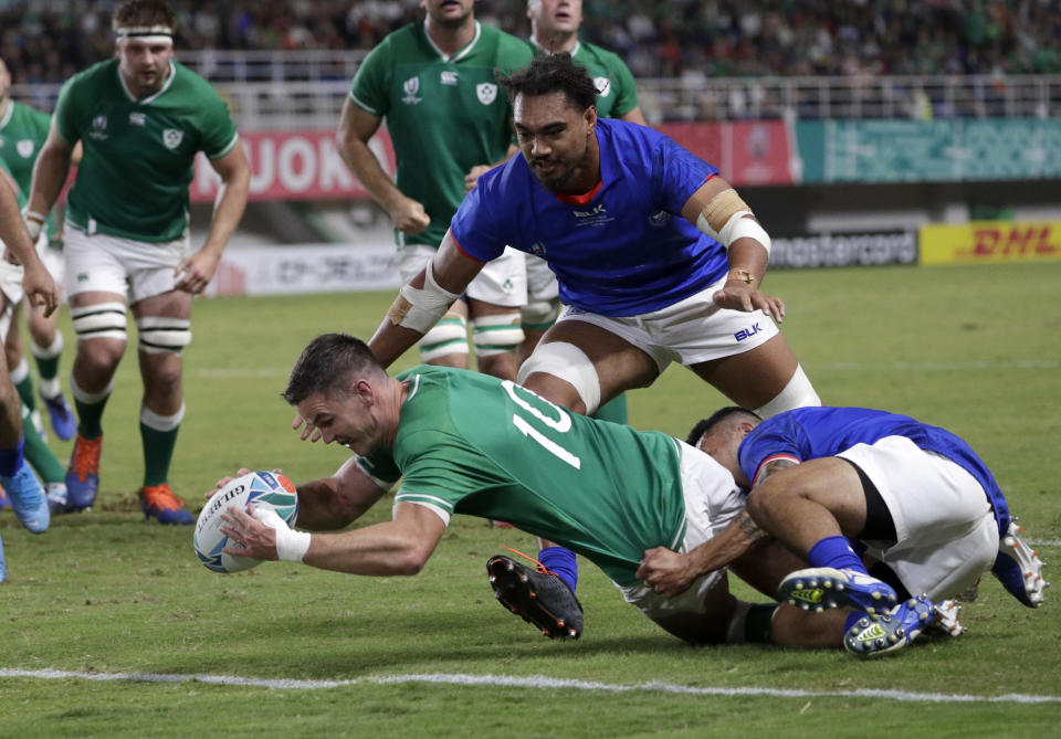 Ireland's Johnny Sexton reaches out to score a try during the Rugby World Cup Pool A game at Fukuoka Hakatanomori Stadium between Ireland and Samoa, in Fukuoka, Japan, Saturday, Oct. 12, 2019. (AP Photo/Aaron Favila)