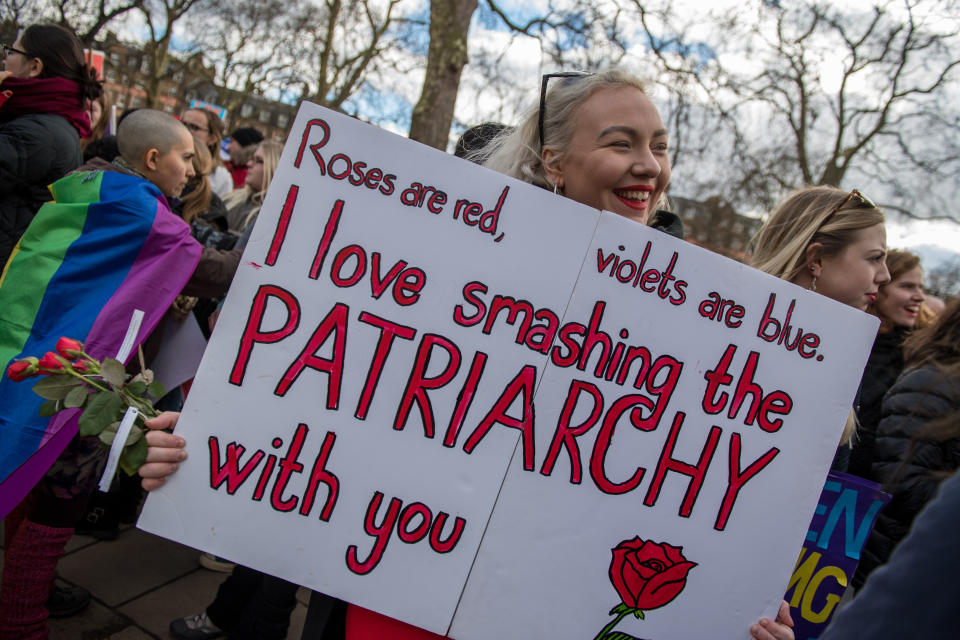 Women's rights demonstrators hold placards during a rally in Russell Square.