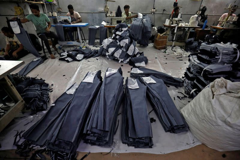 Workers sew jeans in a garments manufacturing unit in Ahmedabad