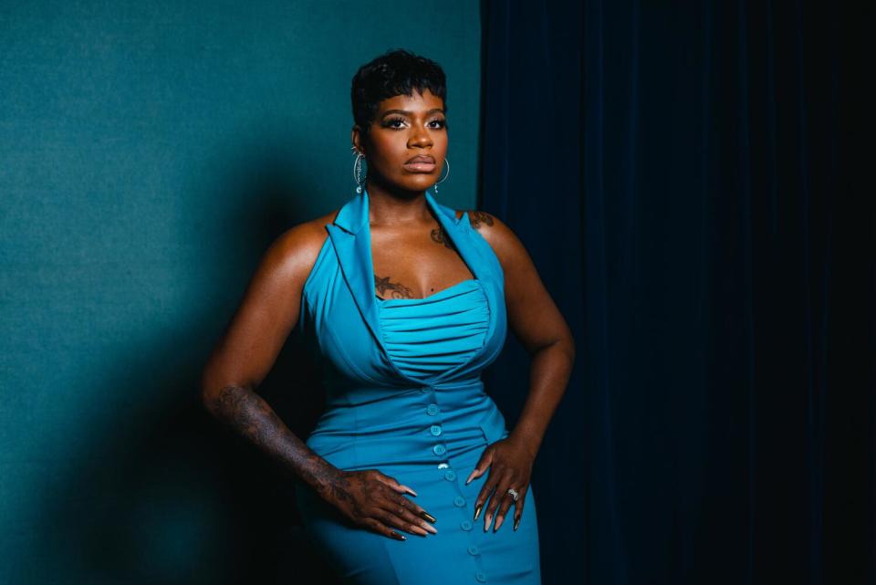 Fantasia Barrino shows her long fingernails for a portrait.