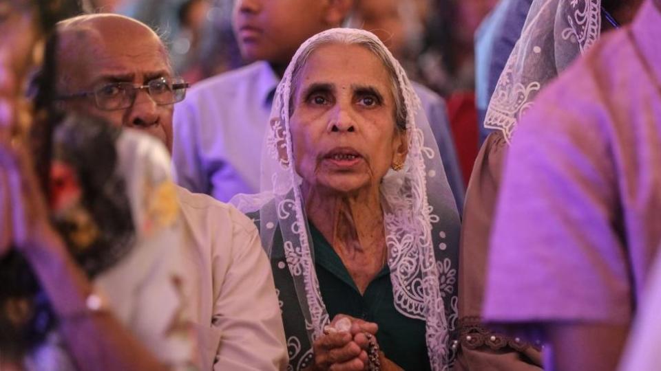 Worshippers attend Christmas Eve midnight mass at the St. Francis Xavier's Church in Katana, Sri Lanka, early 25 December 2023.