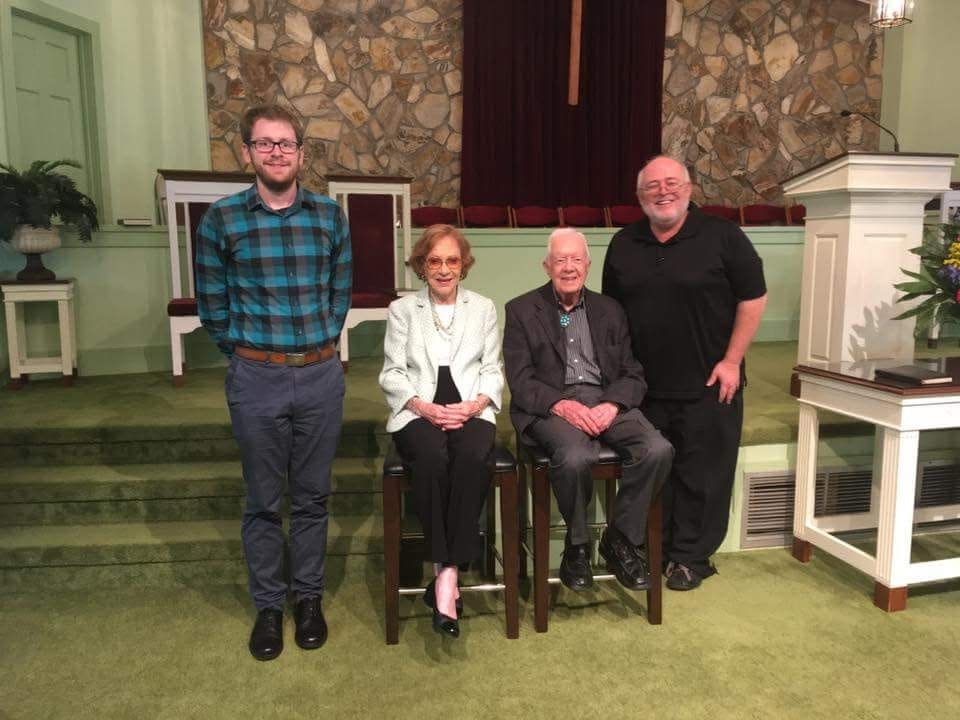Daytona Beach News-Journal reporter Jim Abbott (at right) and former colleague Austin Fuller (at left) pose for a photo with Jimmy and Rosalynn Carter in 2017 at Maranatha Baptist Church in Plains, Ga.